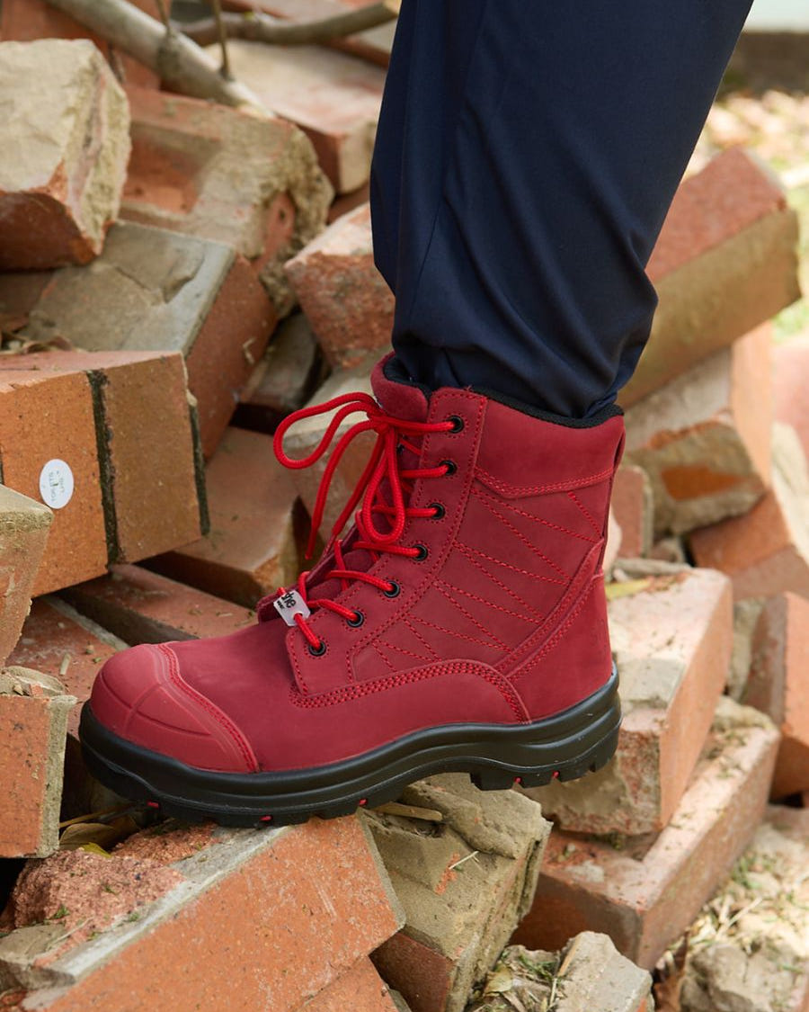 Limited edition red lace-up safety boots with a black sole.