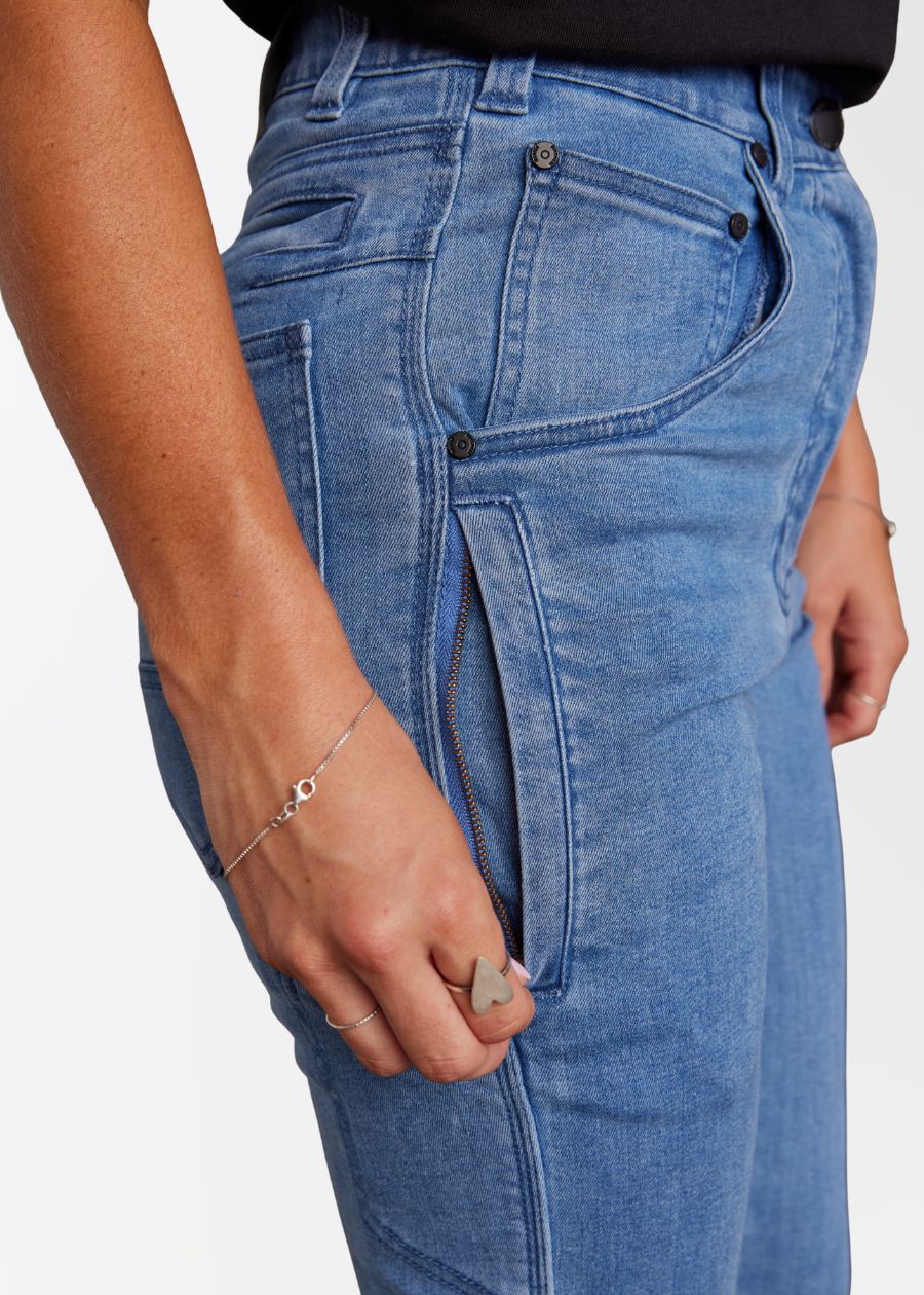Close up side pocket with zip in a pair of blue jeans