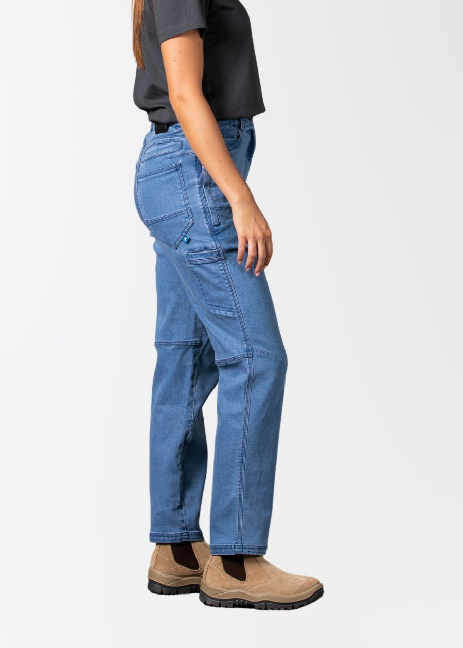 Side view of a woman wearing light wash blue stretch jeans