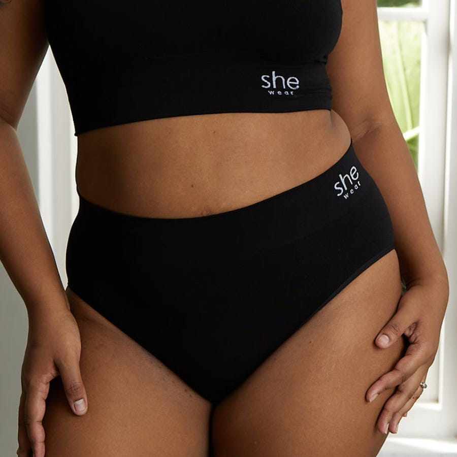 front view from shoulder to knees of woman in full coverage organic bamboo underwear set