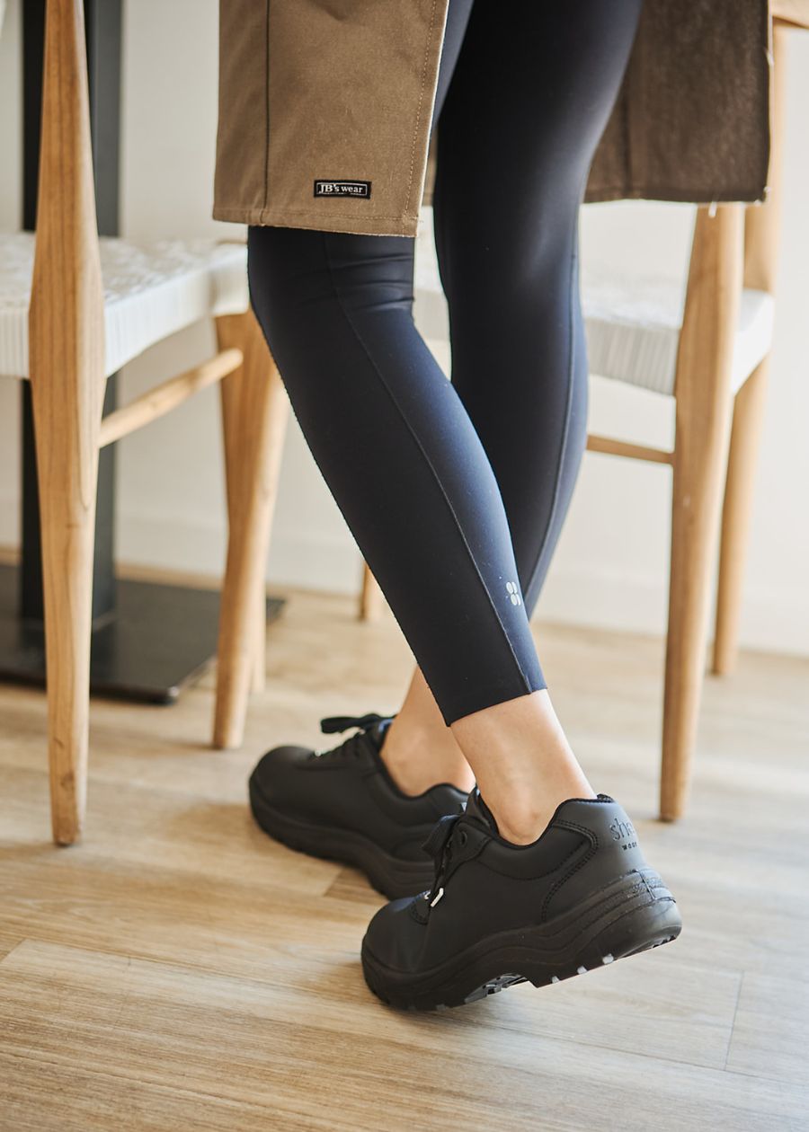 hospitality worker in black slip resistant work shoes