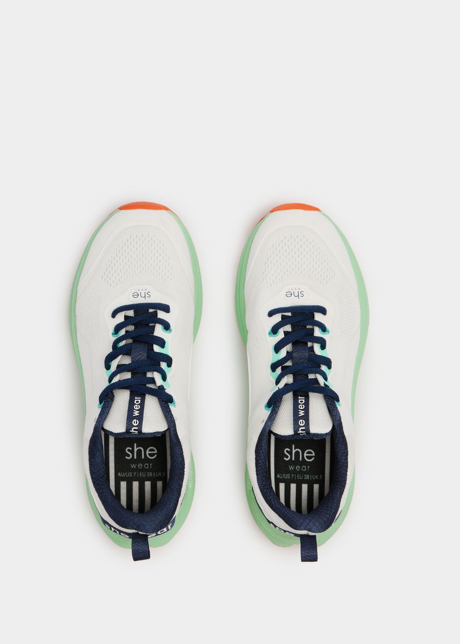 Birds eye view of white walking shoe with navy laces and navy inner lining