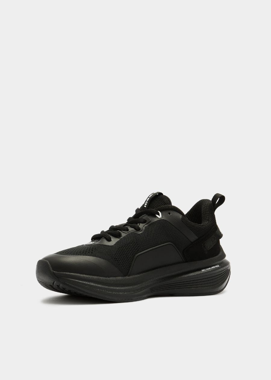 Black walking sneaker side view of rocker sole