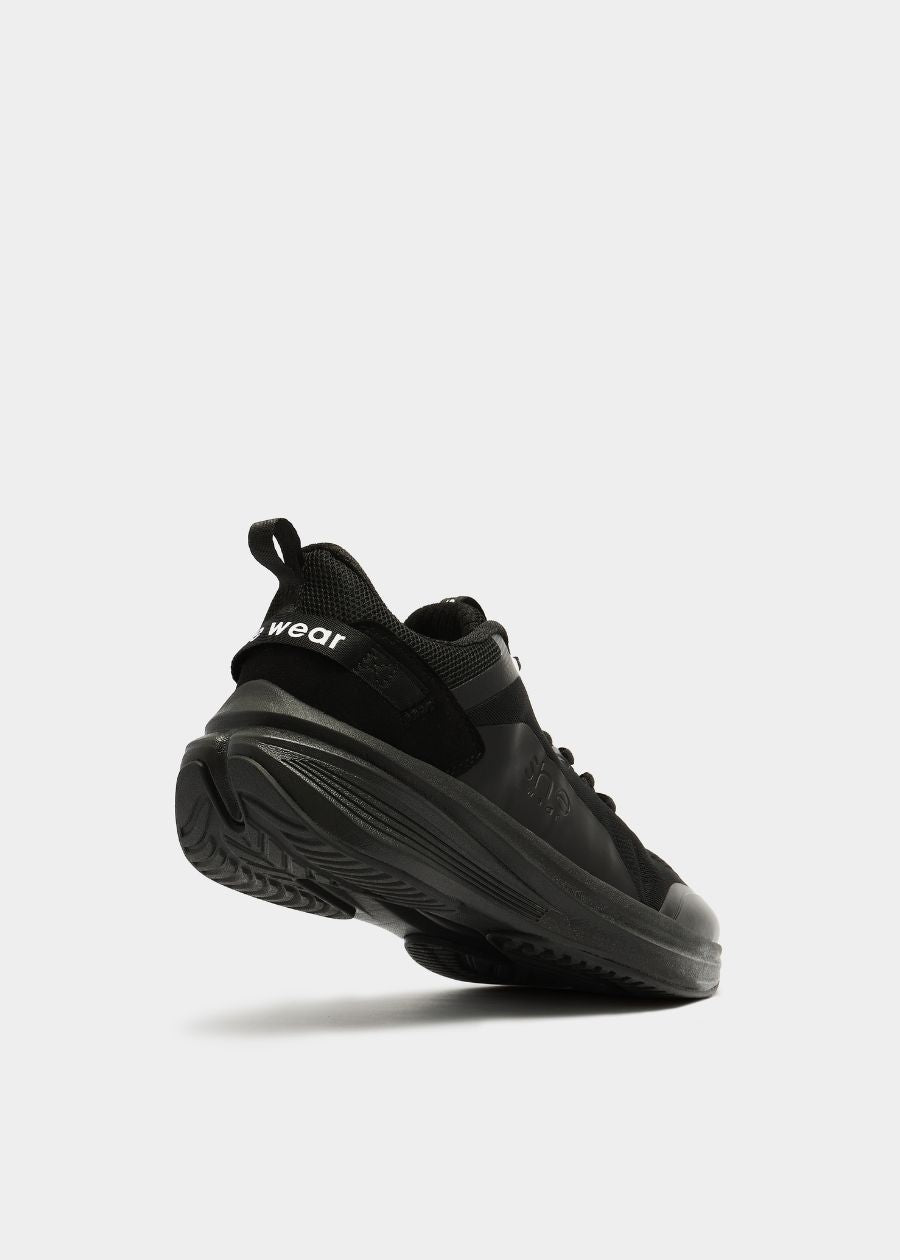 Back angled view of she wear Pace women's walking shoe in black, showing sole grip and supportive design