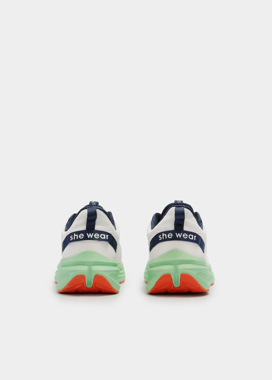 Rear view of she wear Pace women's walking shoe in white with a navy blue heel loop