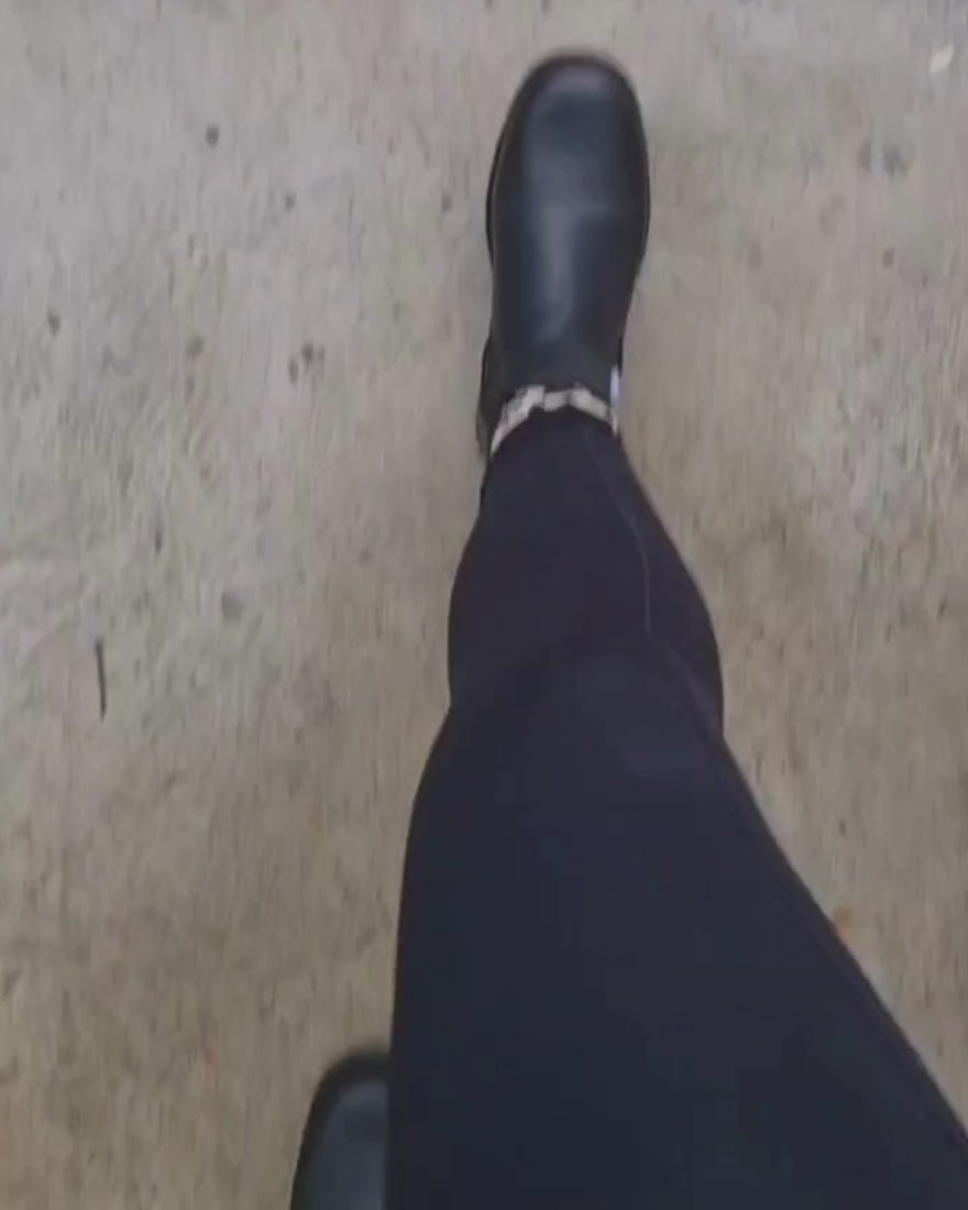 walking in black leather boots