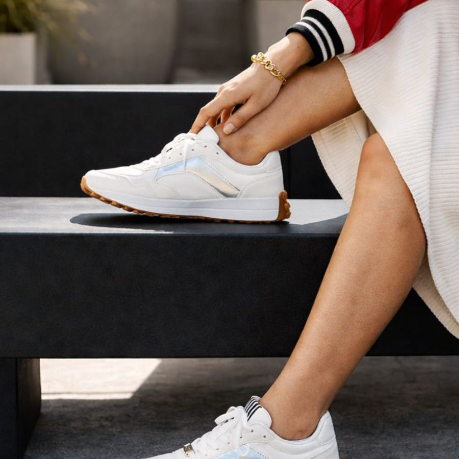White microfibre lace up sneakers with silver accent colours.