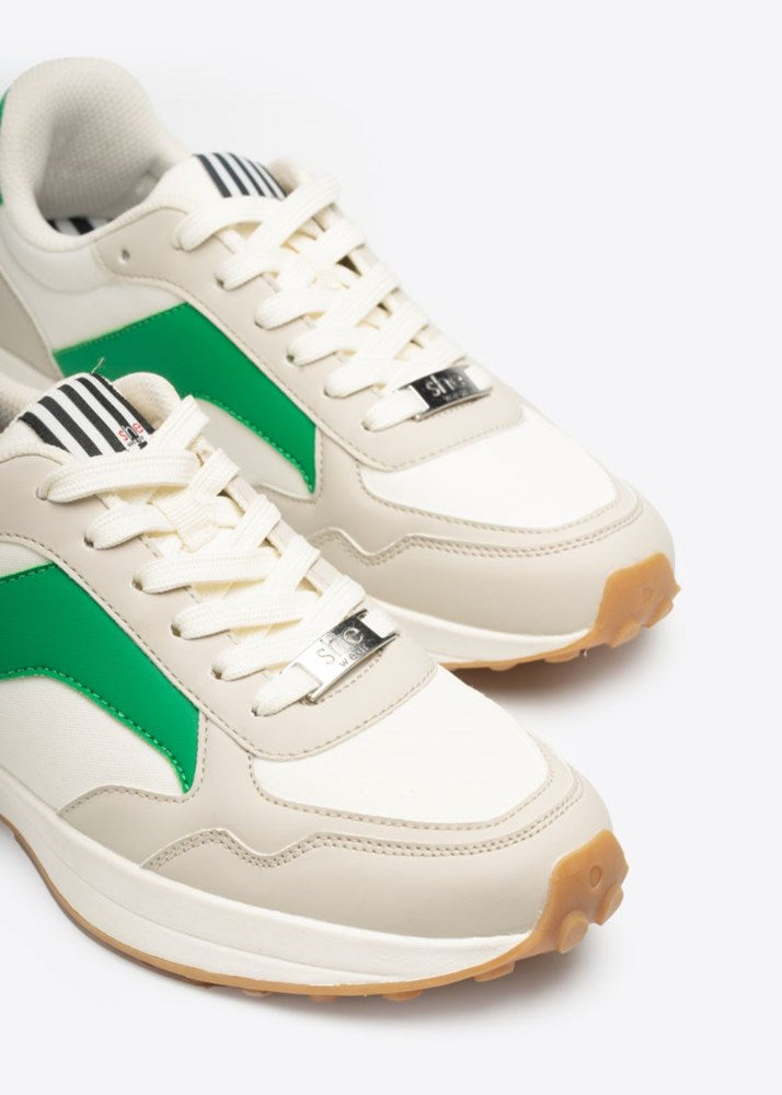White, green, and stone colouring on a pair of women's fashion sneakers