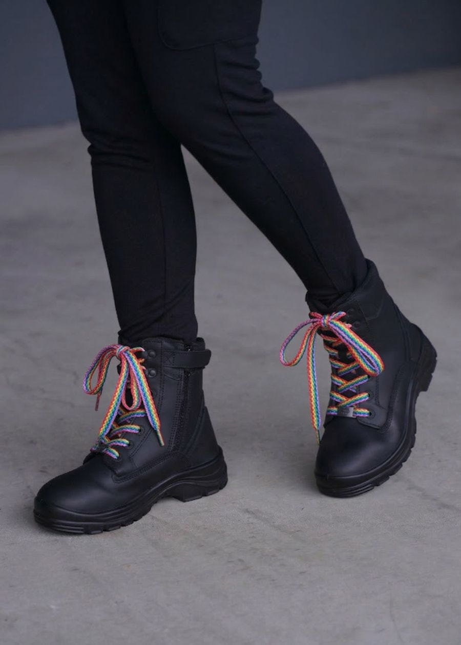 Rainbow boot laces on black zip-up boots.