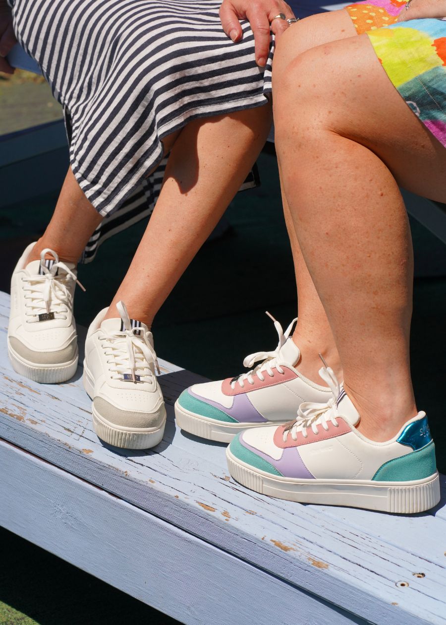 Two women wearing two pairs of platform sneakers with Slip resistant, shock absorbing TPR soles