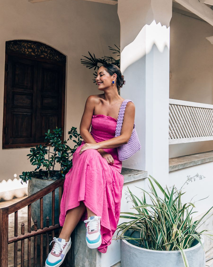 lady in pink wearing she wear rise sneakers