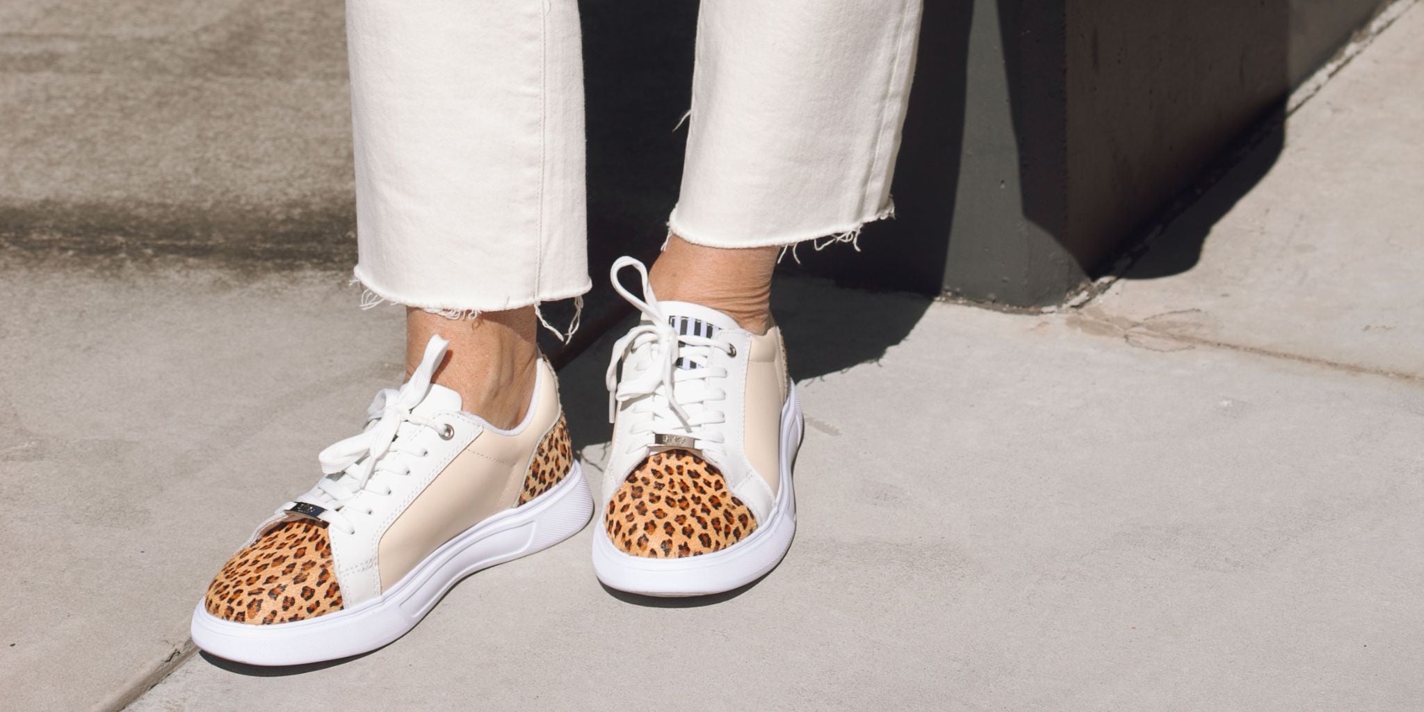 Close up of beige and leopard print lace-up sneakers.