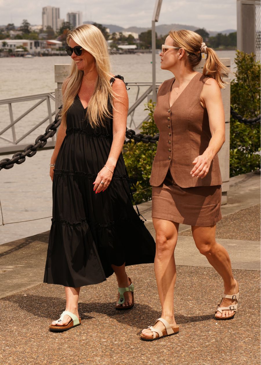 she wears supportive all day slides walking by the river