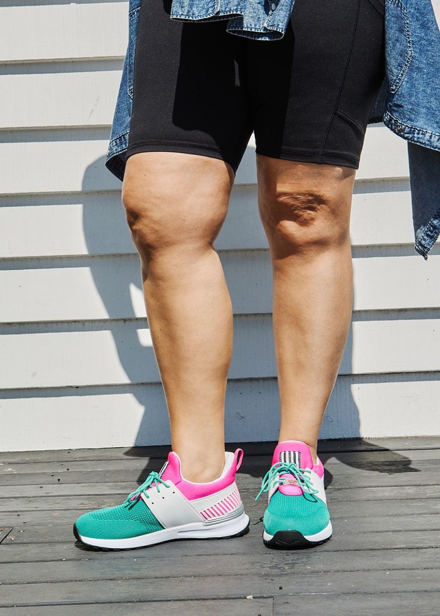 Women wearing pink, white and aqua sneakers active sneaker on patio.