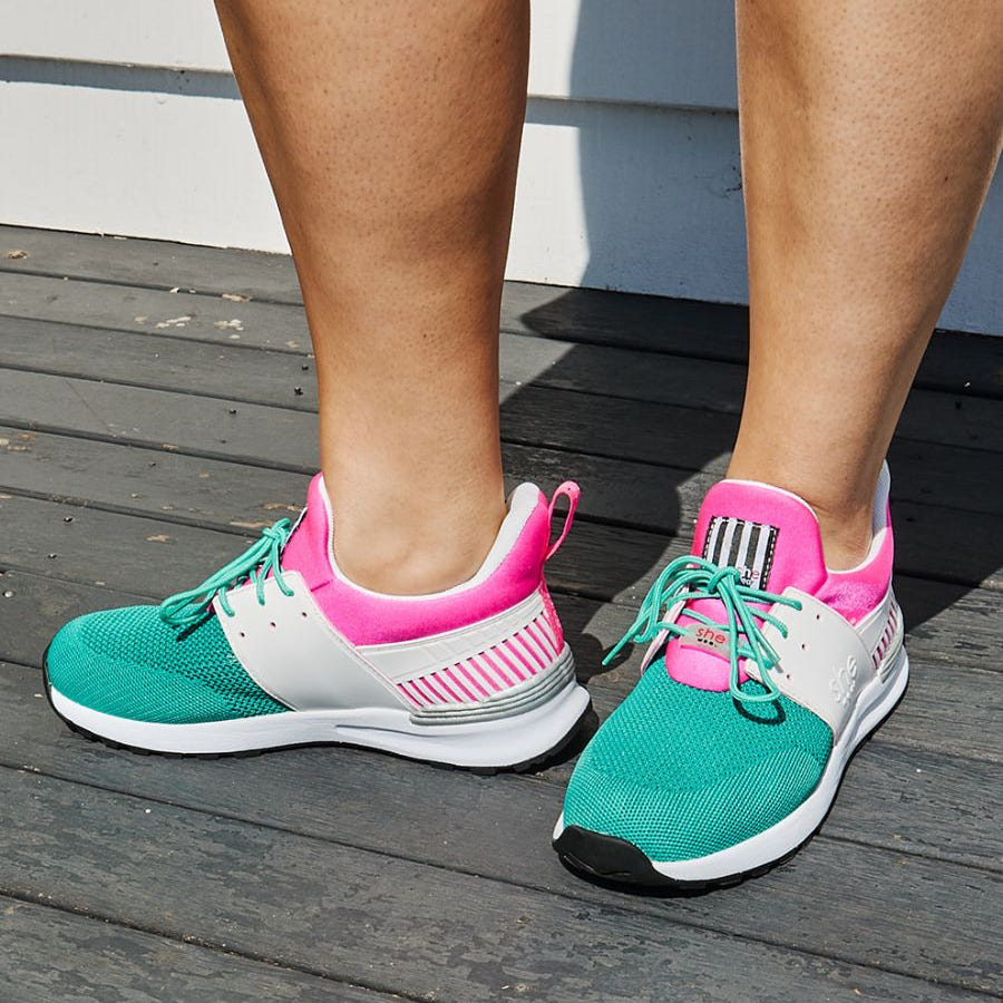 Close up, women's active sneaker in pink, white, and mint green with green laces.