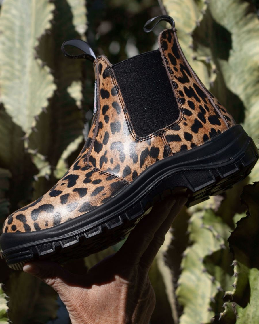Side profile of a pull-on boot, with black sole and leopard printed leather
