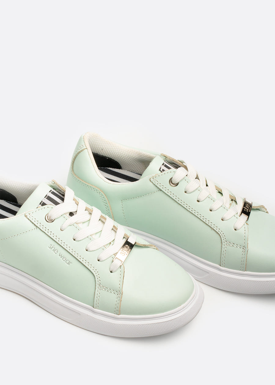 A pair of pastel green sneakers with a Bio mechanical anti fatigue footbed