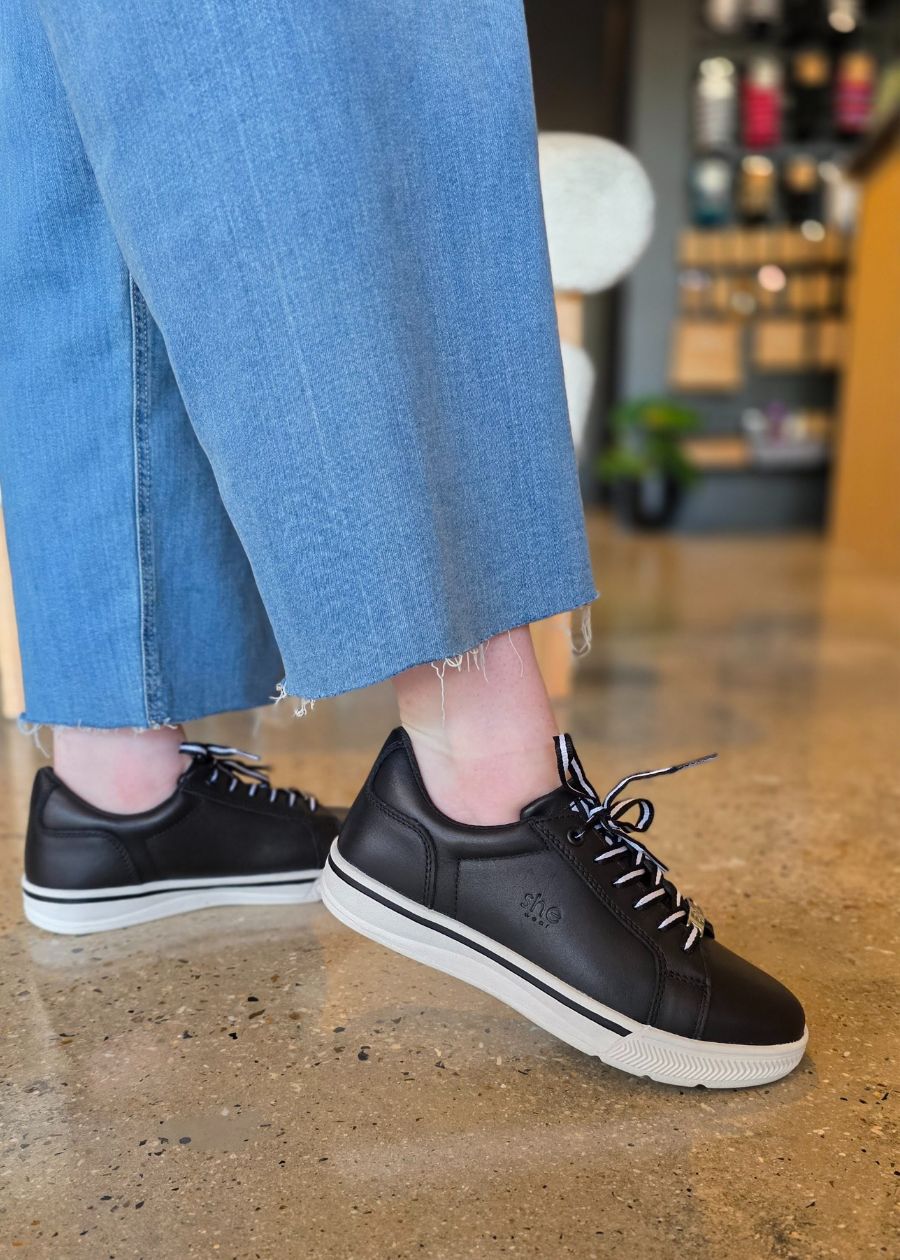 Supportive black and white leather work sneakers.