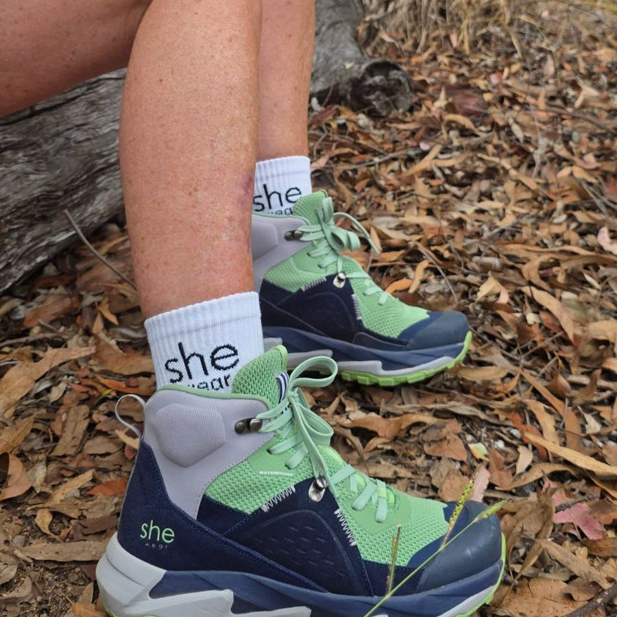 trek is she wears new womens hiking boots on woman sitting on log in bush