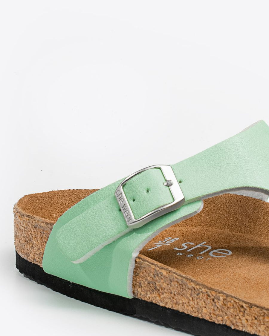 Silver buckle detail on Wander women's slides in honeydew