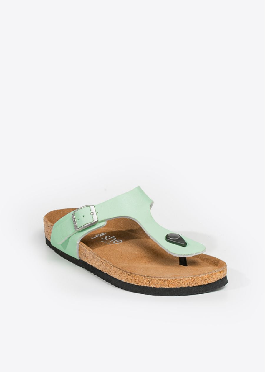 Front view of casual cork-style sandals in the shade of honeydew