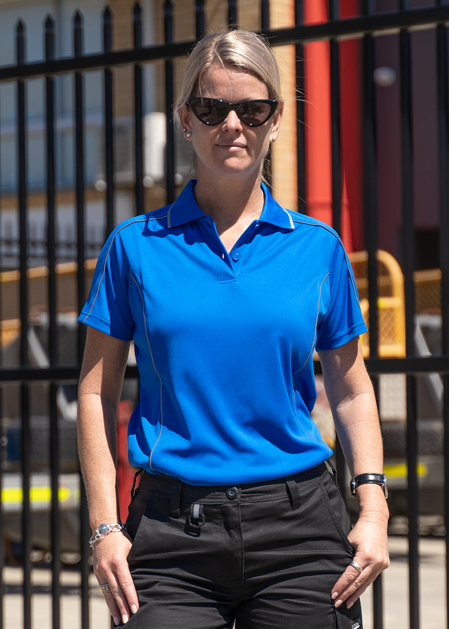 Bisley women's blue cool mesh polo shirt on a model in a industrial location