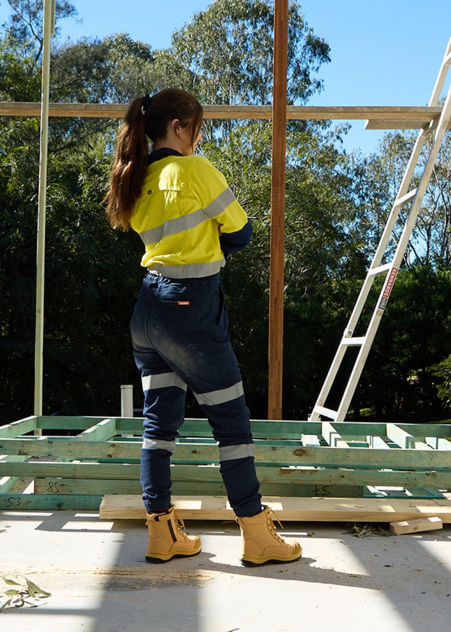 Back view of high vis, long sleeve, yellow work top with navy collar.  