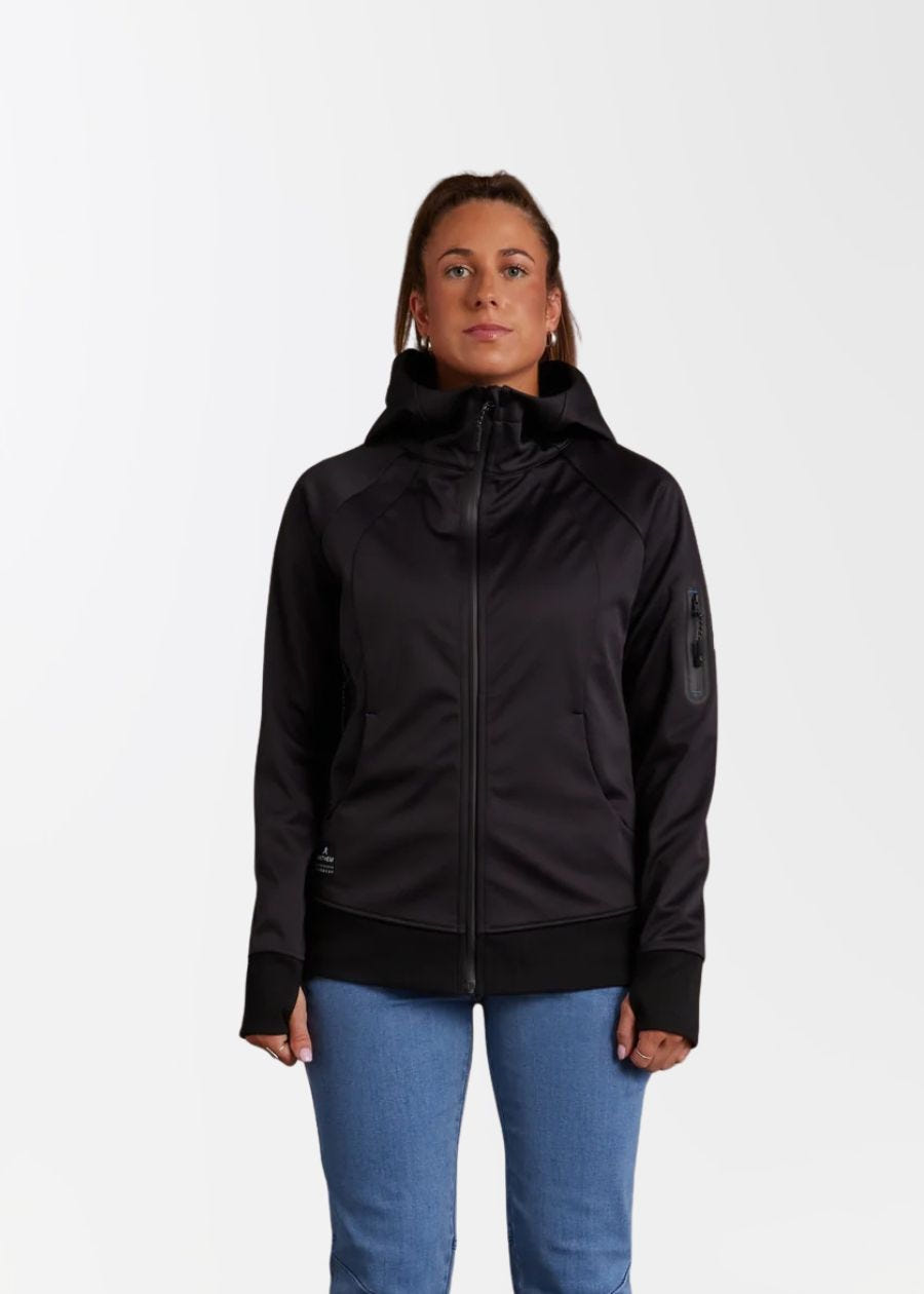 Front view of zipped up black soft shell jacket with thumb holes. 