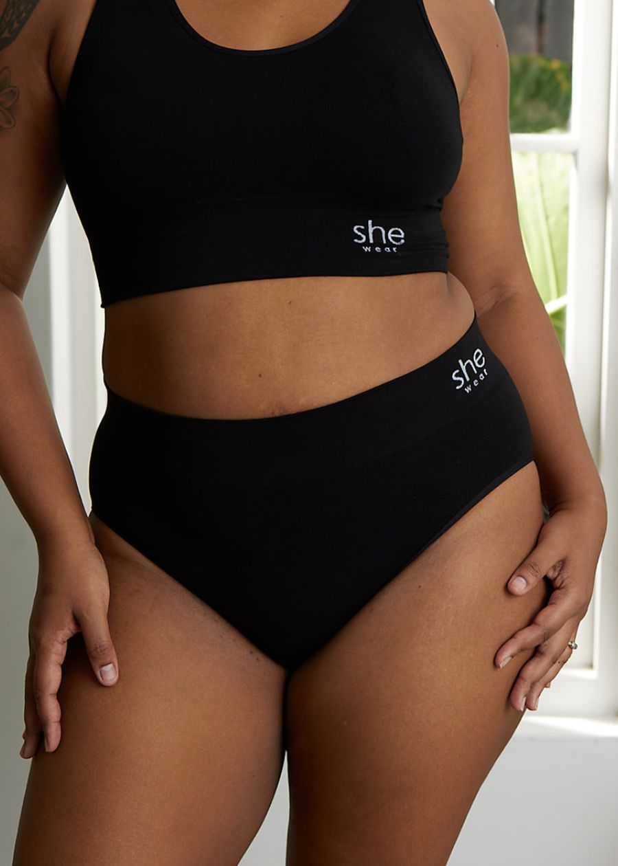 front view from shoulder to knees of woman in full coverage organic bamboo underwear set