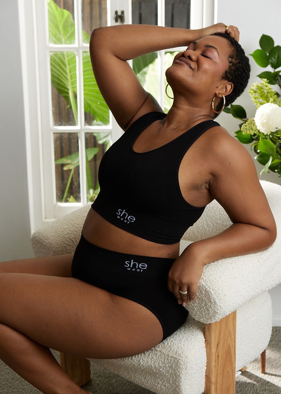A woman wears a comfortable bamboo bra and black bamboo underwear