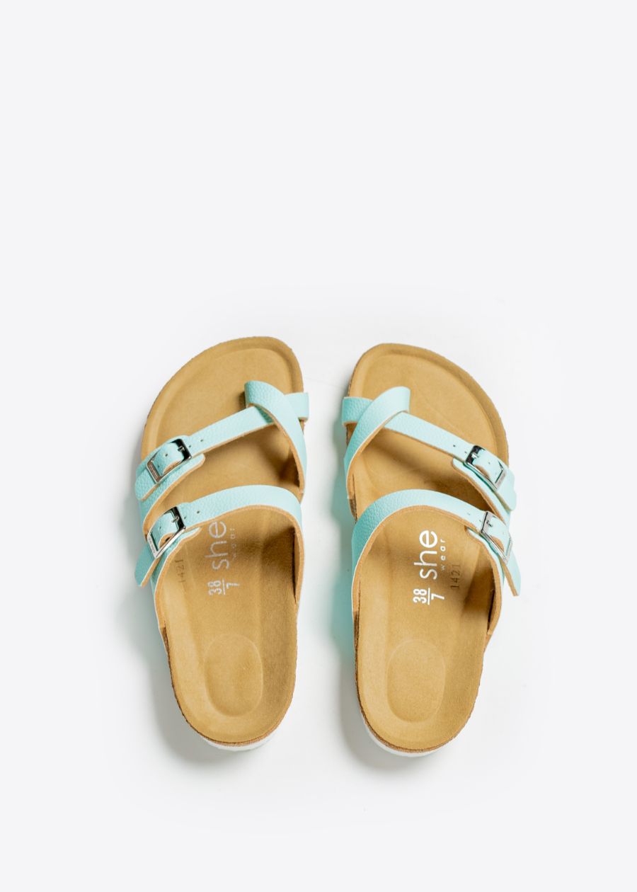 A pair of sandals with three leather straps