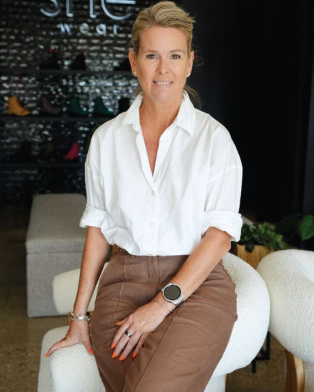 Founder  - Stacey Head sitting in she wear retail store 