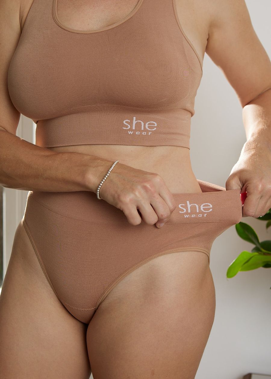 Woman demonstrating stretch on  waistband for organic bamboo briefs