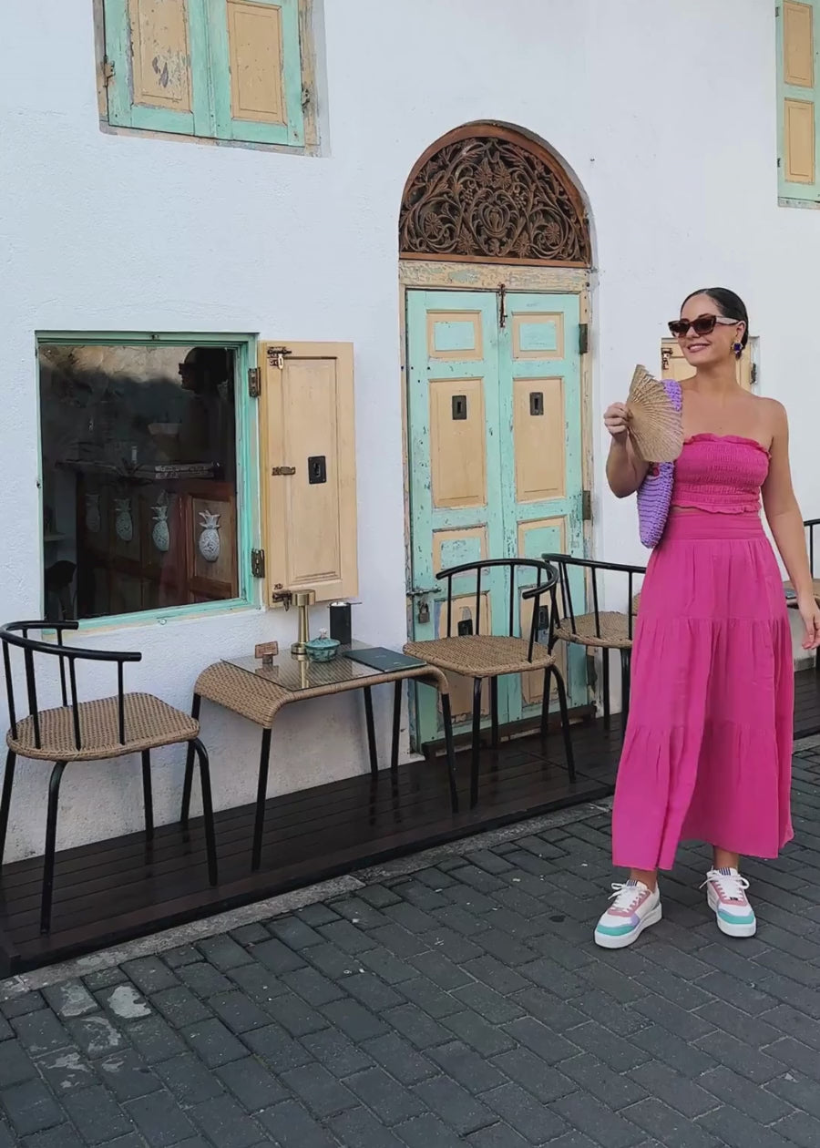 woman travelling comfortably with her she wear rise pastel coloured sneakers