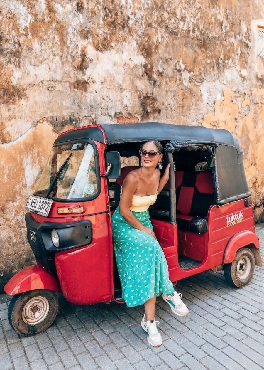 Lady sitting in red vehicle wearing Pulse sneakers. 