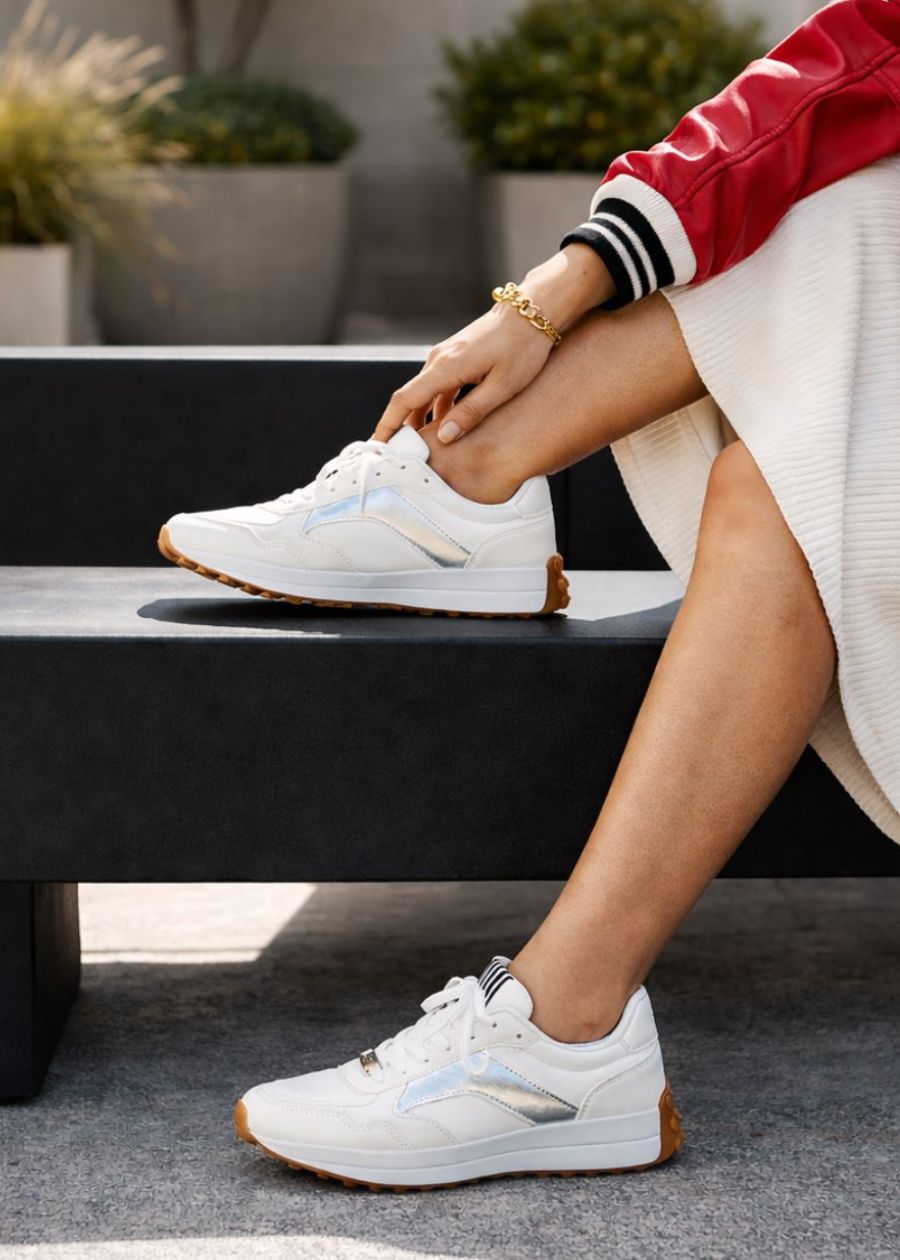 White microfibre lace up sneakers with silver accent colours. 