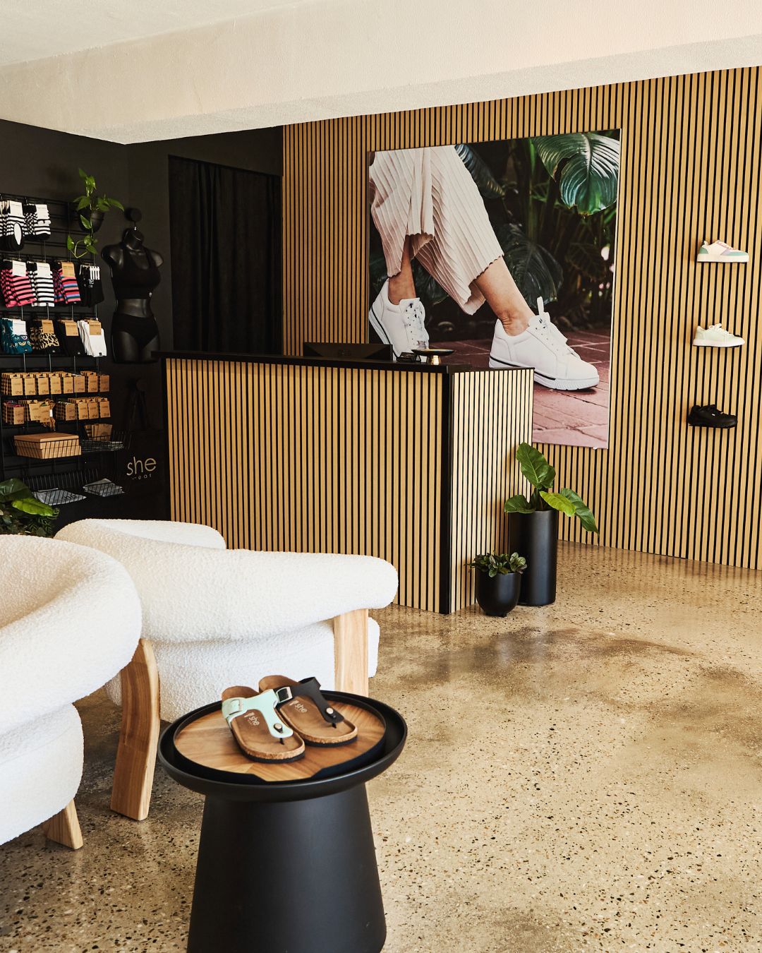 inside she wear's Hamilton store. View of seating and front desk 