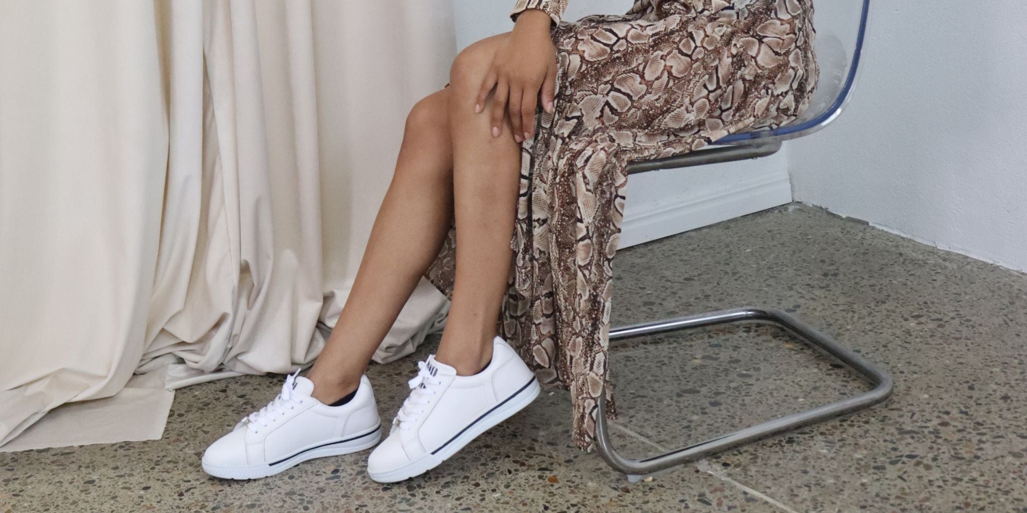 Close up of woman wearing white supportive dress sneakers 
