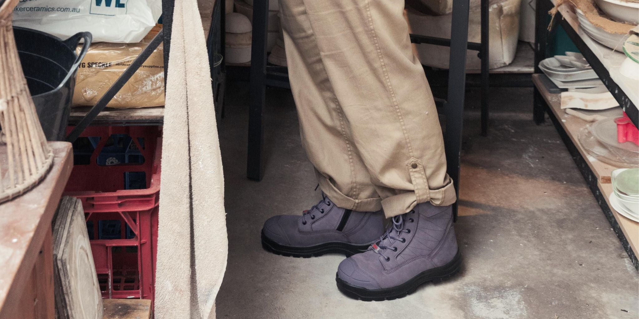 purple lace up work boots in pottery studio 