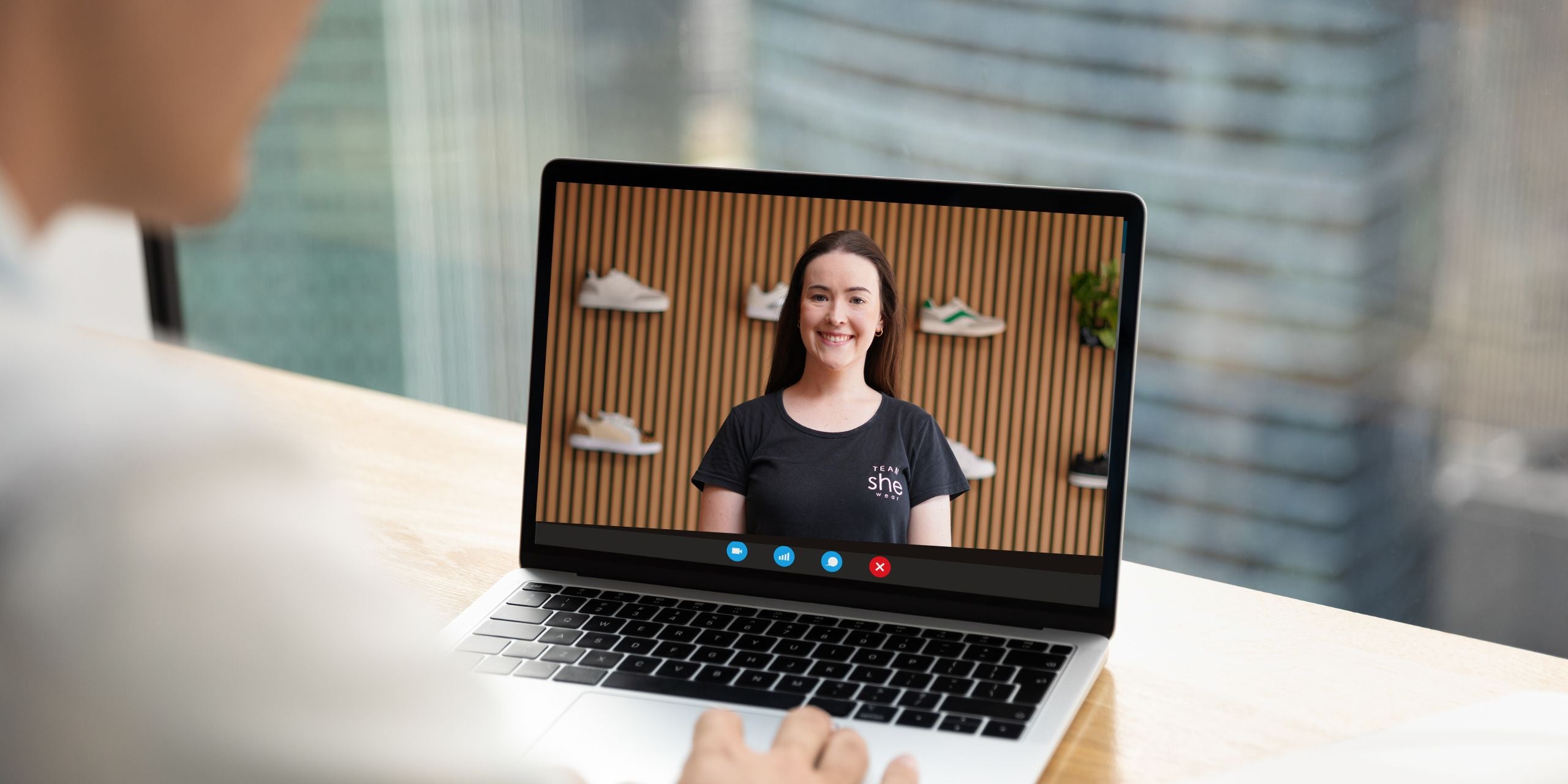 Person using laptop to attend a virtual fitting appointment.