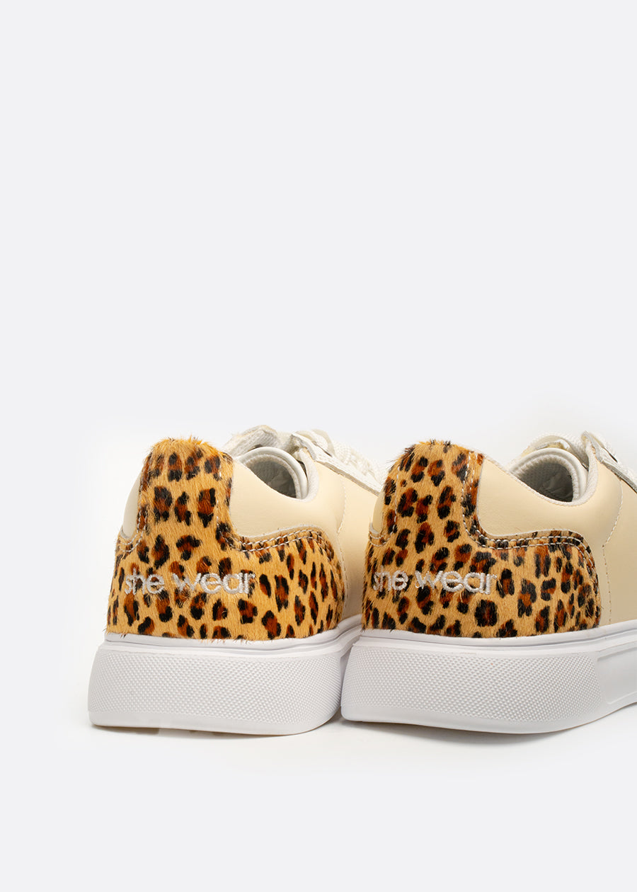 Cheetah print fur on the heels of a pair of sneakers