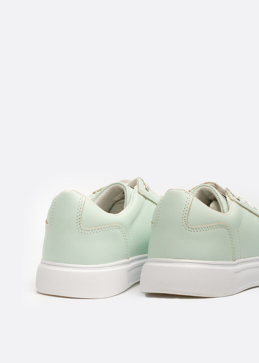Padded heel collar on a pair of mint green sneakers