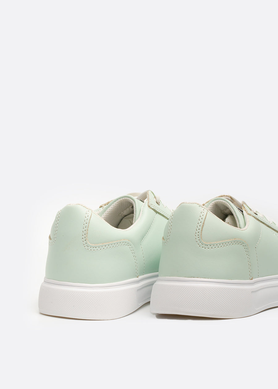 Padded heel collar on a pair of mint green sneakers