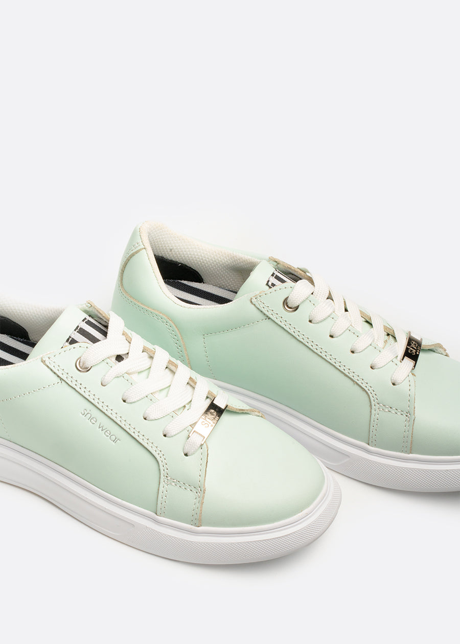 A pair of pastel green sneakers with a Bio mechanical anti fatigue footbed