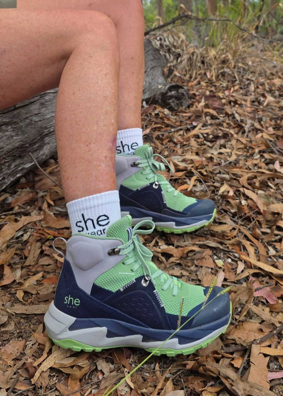 trek is she wears new womens hiking boots on woman sitting on log in bush