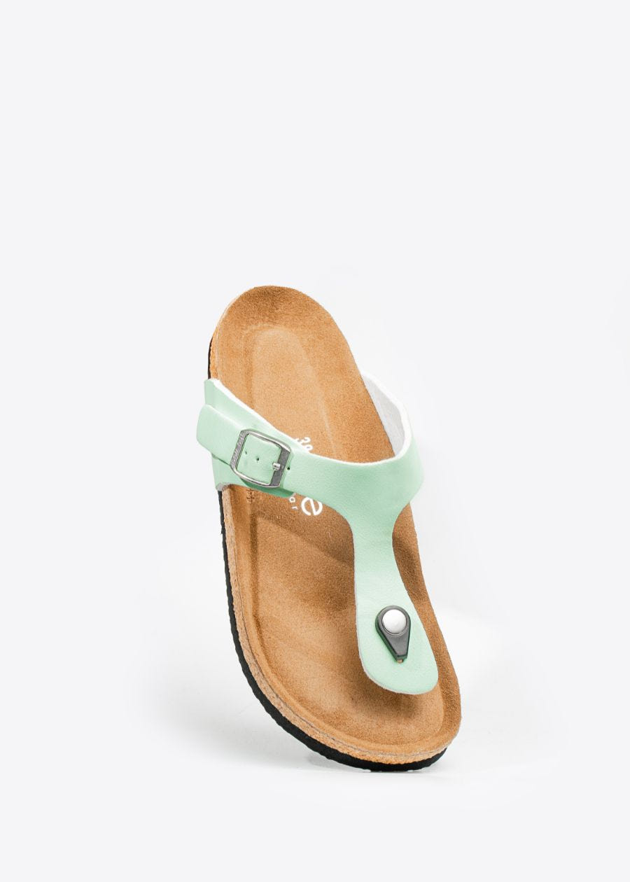Front, tilted view of women's  thong style, cork slip-on shoe in the colour honeydew